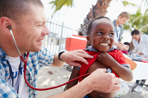 A doctor in Africa with a kid